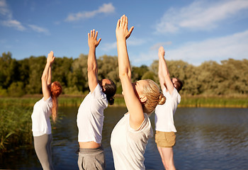 Image showing group of people making yoga exercises outdoors