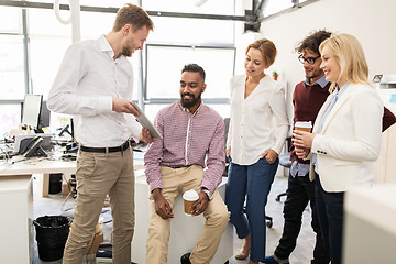 Image showing business team with tablet pc and coffee at office