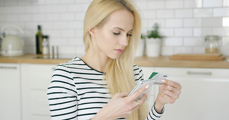 Image showing Woman buying in Internet through phone