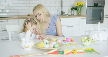 Image showing Mother and daughter coloring eggs