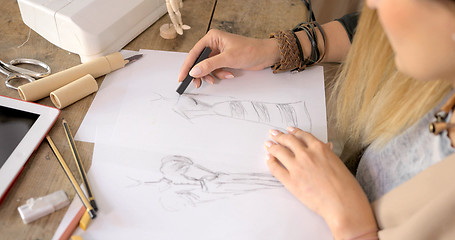 Image showing Crop shot of dressmaker drawing sketches