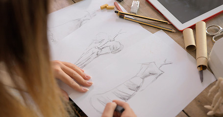 Image showing Crop shot of dressmaker drawing sketches