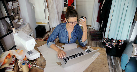 Image showing Female with laptop and coffee in parlour