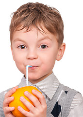 Image showing Little boy drinking orange juice