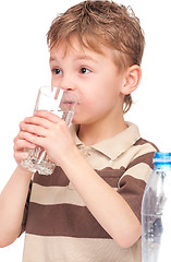 Image showing Boy with glass and plastic bottle of water