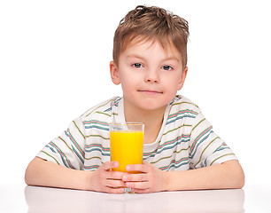 Image showing Boy drinking refreshing orange juice