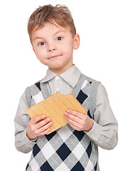 Image showing Boy eating waffle isolated on white