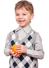 Image showing Little boy drinking orange juice