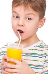 Image showing Boy drinking refreshing orange juice