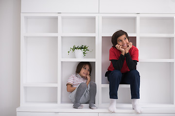 Image showing young boys posing on a shelf