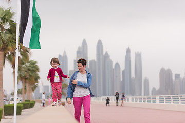 Image showing mother and cute little girl on the promenade