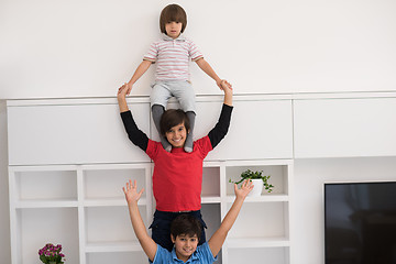 Image showing young boys posing line up piggyback