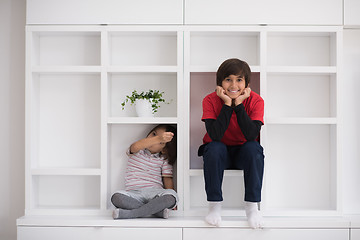 Image showing young boys posing on a shelf