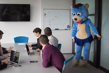 Image showing boss dresed as bear having fun with business people in trendy of