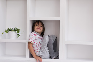 Image showing young boy posing on a shelf