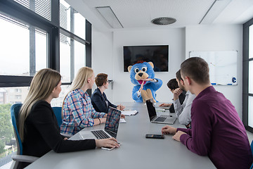 Image showing boss dresed as bear having fun with business people in trendy of