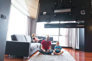 Image showing Happy family playing a video game