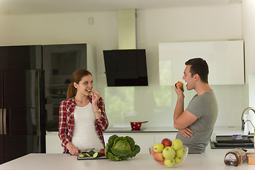 Image showing Young handsome couple in the kitchen