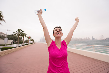 Image showing young woman celebrating a successful training run