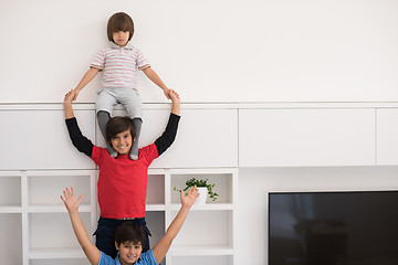 Image showing young boys posing line up piggyback