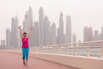 Image showing young woman celebrating a successful training run