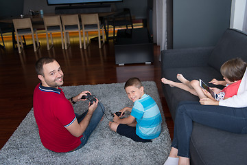 Image showing Happy family playing a video game