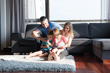 Image showing happy young couple spending time with kids