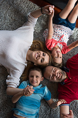 Image showing happy family lying on the floor