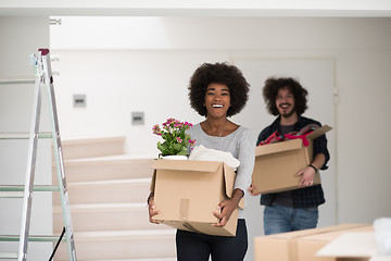 Image showing multiethnic couple moving into a new home