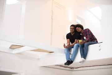 Image showing couple having break during moving to new house