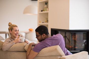 Image showing Young multiethnic couple  in front of fireplace