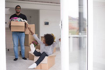 Image showing African American couple  playing with packing material