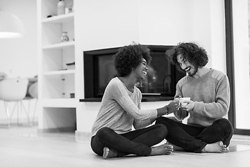 Image showing multiethnic couple  in front of fireplace