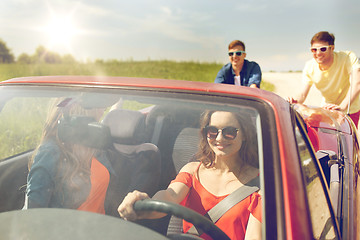 Image showing happy friends pushing broken cabriolet car