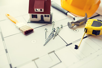 Image showing close up of house blueprint with building tools