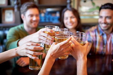 Image showing happy friends drinking beer at bar or pub