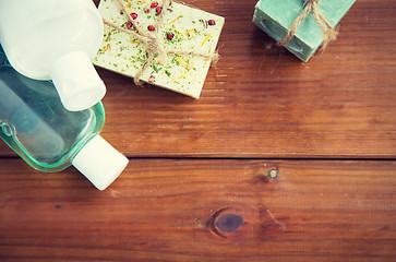 Image showing close up of handmade soap bars and lotions on wood