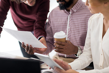 Image showing business team with papers and coffee at office