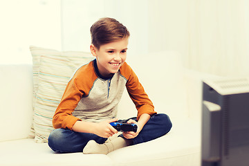 Image showing happy boy with joystick playing video game at home