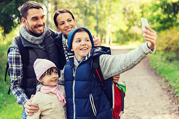 Image showing family with backpacks taking selfie by smartphone