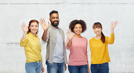 Image showing international group of happy people waving hands