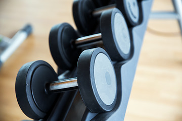 Image showing close up of dumbbells and sports equipment in gym