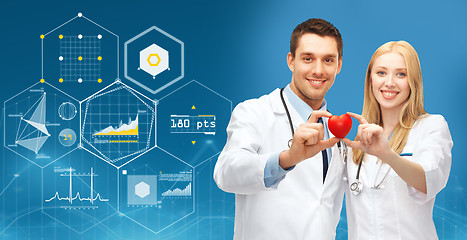 Image showing doctors with red heart and charts over blue