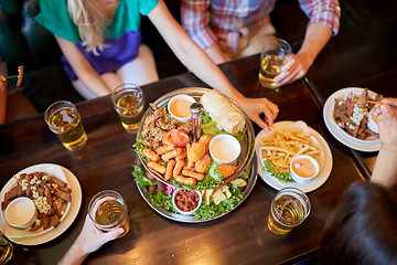 Image showing friends eating and drinking at bar or pub