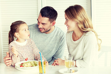 Image showing happy family having dinner at restaurant or cafe