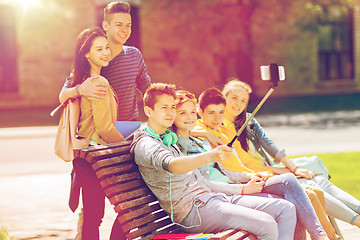 Image showing happy teenage students taking selfie by smartphone