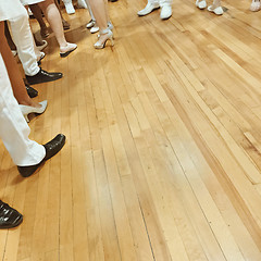 Image showing People\'s feet on parquet floor