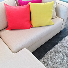 Image showing Bright cushions on gray corner sofa