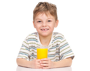 Image showing Little boy drinking orange juice