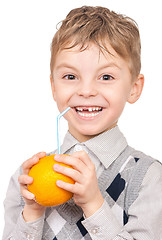 Image showing Little boy drinking orange juice